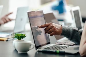 Close up of a finger pointing at a laptop screen